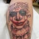 This tattoo is often rendered in black and gray, but incorporating color works as well. The text here says "good times, bad times."