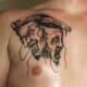 A chest tattoo where the masks are together.
