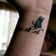 Butterfly tattoo with text.