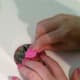 Scrape off excess nail polish...