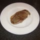 Sirloin steak is rested on a heated plate