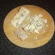 Stilton cheese is crumbled by hand