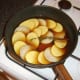 Beef broth is poured over potato and onion slices