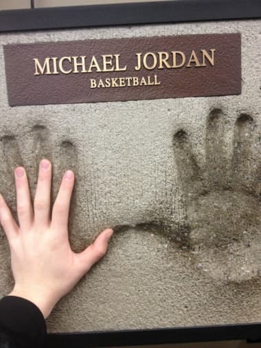 A cement impression of Michael Jordan's hands allows you to test your hand size against those of this basketball legend.