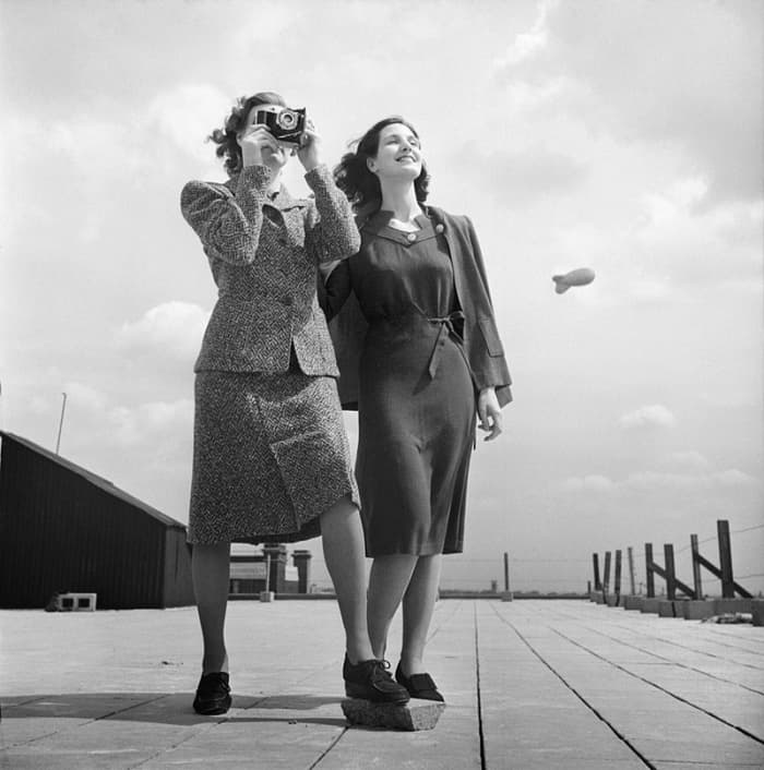 Shorter hemlines, simple lines, and longer hair typified women's fashions in this image from 1943.