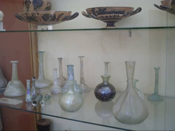 Classic Roman antiques and glass items on display in the Archaelogical Museum on Paros. Photographed by Cedric Boissiere. Courtesy Wiki Commons