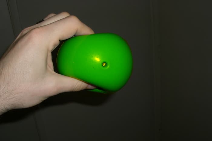 ball give, easily squeezed and soft, supportive, but very very difficult to touch finger tips together when squeezing. Will not pop.