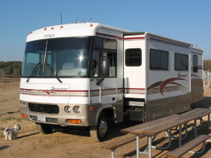 Class A motorhome; the drivers compartment is as wide and as tall as the rest of the vehicle. Notice that the slide is out; this never happens when it is moving.