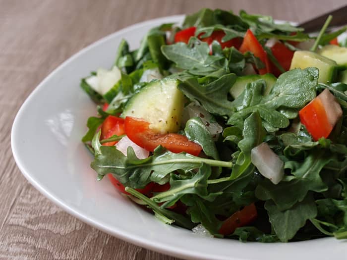 My favorite salad, with only 77 calories, includes arugula, cucumber, red pepper, grape tomatoes, sweet onion, and lemon-garlic vinaigrette.