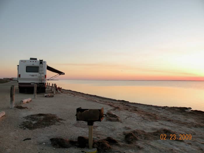 Campsite at Bird Basin, Padre Island National Seashore with a serene view of the sunset on Laguna Madre.