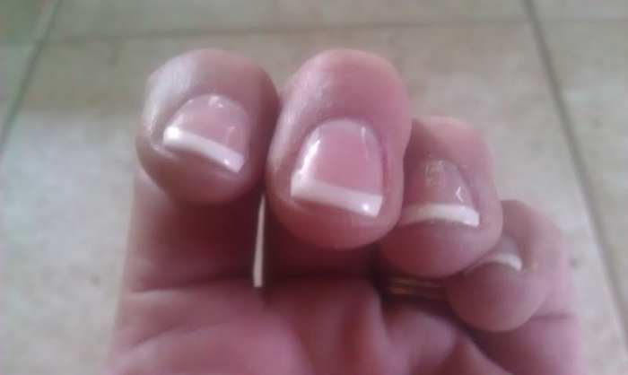 Closeup of a shellac french tip manicure