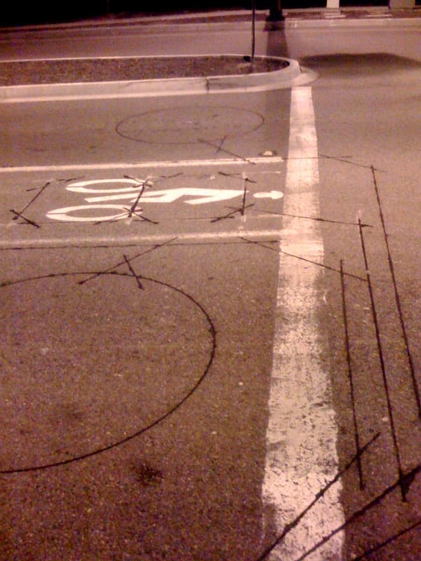 This is a traffic sensor—a detector loop buried in the pavement that sends signals to the traffic control system.