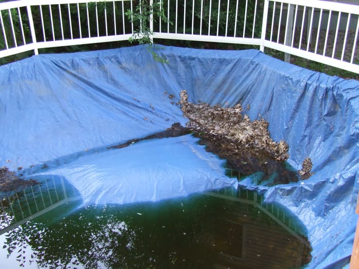 Old-school pool cover. When you have this type of cover, you need to pump the water off the cover before you remove it.