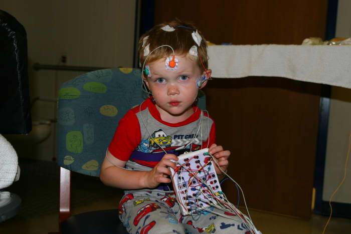 Sleep studies require a lot of sensors and wires. In this photo, our son has about half the required sensors attached.