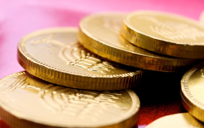 Chocolate gelt coins such as these (featuring a hanukkiah design) are often handed out during Hanukkah, but the holiday tradition has a basis in real money.