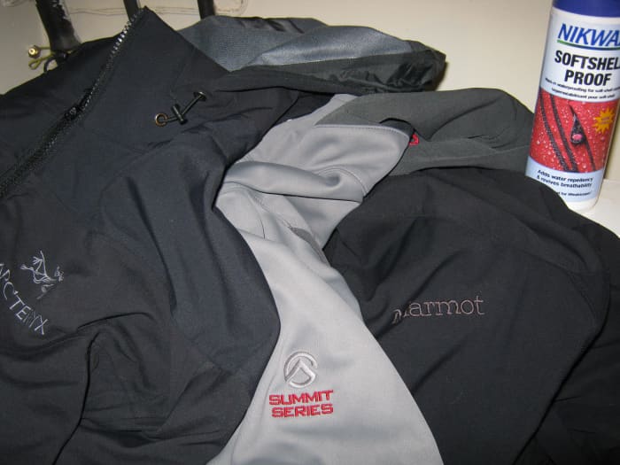 Three softshell jackets from Arc'Teryx, The North Face, and Marmot getting ready for a Nikwax cleaning and waterproofing treatment.