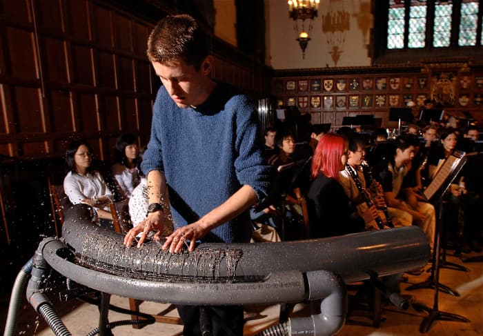 Ryan Janzen playing a hydraulophone in a concert rehearsal