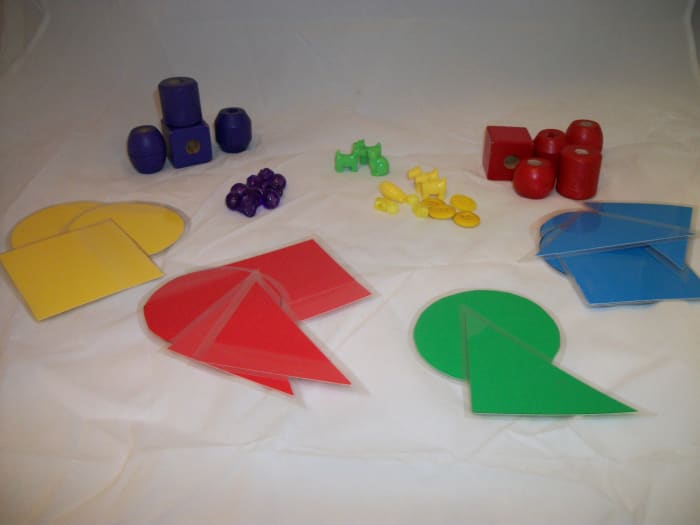 Large beads, small beads, animal beads, buttons, and laminated shapes sorted by color.