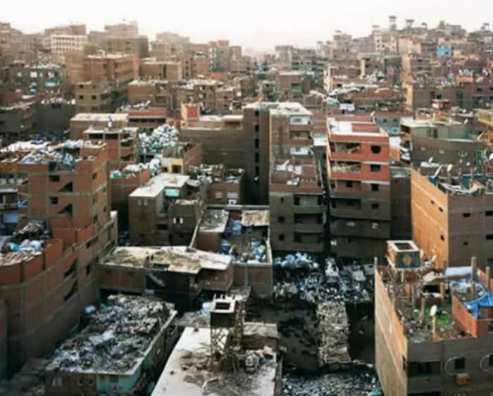 This is Manshyiat Naser—the "City of Garbage"—a suburb of Cairo where all of the refuse of an overpopulated city are brought to be picked over and recycled by the poorest of the poor.