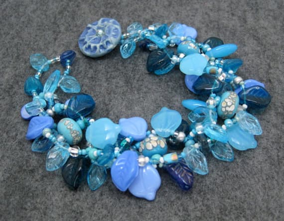 Even though I don't make a lot of beads, I love to use handmade beads in my creations. The round blue spotted beads beads are from Jen of blueseraphim on Etsy.