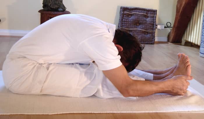 Paschimottanasana or sitting forward bend is an excellent yoga pose for stretching tight hamstrings.