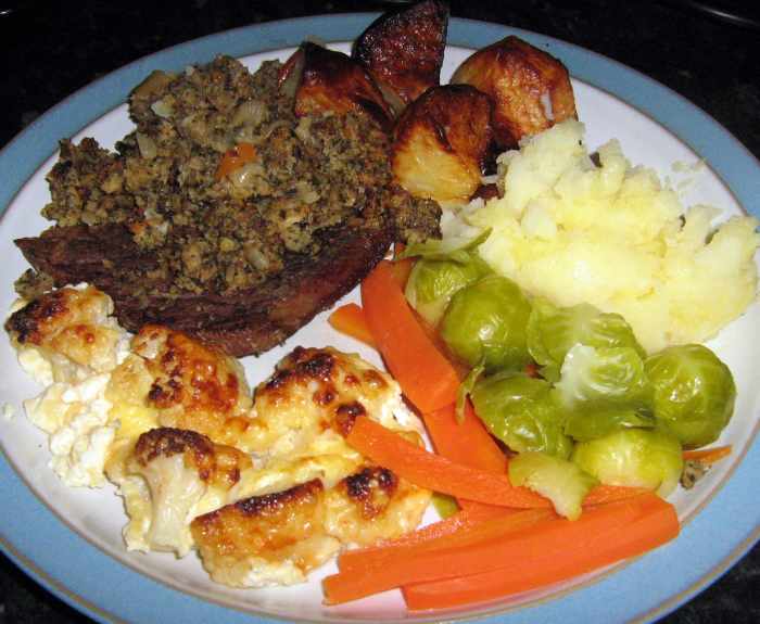 Learn how to make oven-cooked steak with stuffing and cauliflower cheese. 