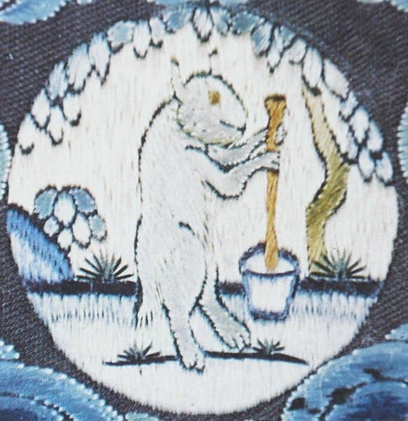 A medallion on an 18th century Chinese emperor's robe depicting the Moon Rabbit mixing its elixir of life at the foot of a cassia tree.