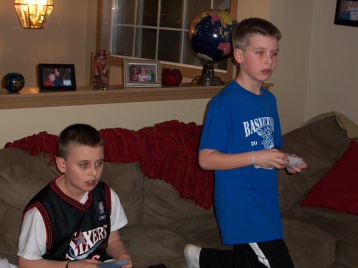  Junge mit Asperger und ein Freund spielen verschiedene Videospiele nebeneinander