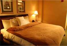Soft lighting, plush bedding and zero clutter make this bedroom a peaceful, heavenly haven.