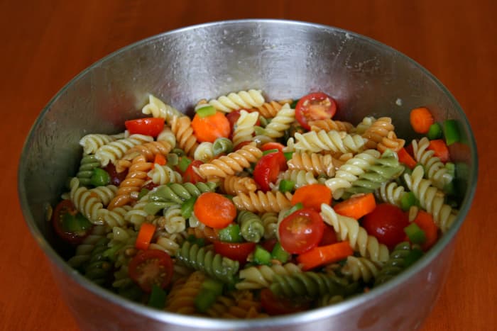 This pasta salad recipe includes rotini pasta, Italian dressing, vegetables, and sunflower seeds.