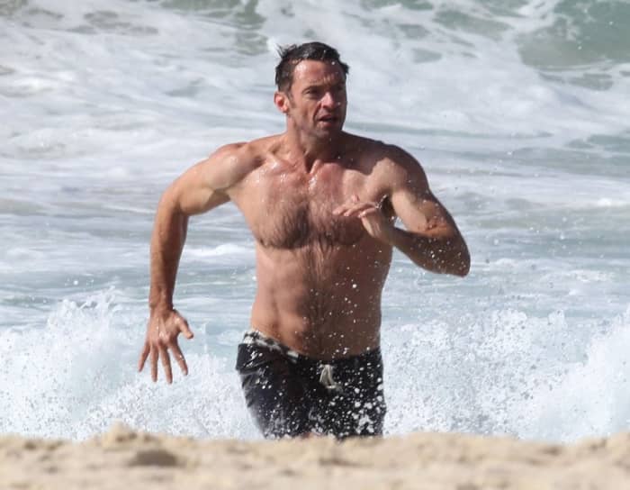 Shirtless Hugh Jackman on Bondi Beach. He may not be the guy with the biggest body in tinsel town but his muscular and well proportioned body is definitely eye candy for the fairer sex.