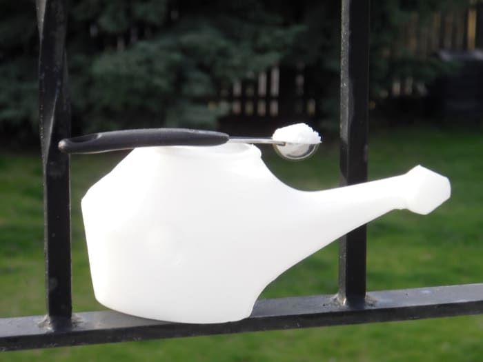 1/4 teaspoon of sea salt in about 1/2 cup of water in the neti pot helps wash the mucous membranes and stop a runny nose without drugs.