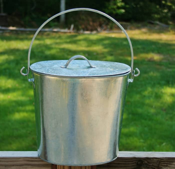 Collect kitchen scraps & other organic household waste in a receptacle with a tight-fitting lid.