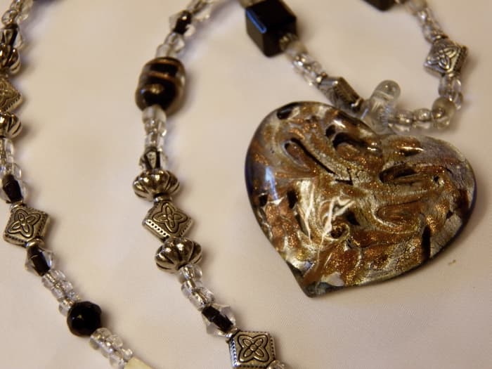 Learn how to handcraft your own jewelry, like this beaded necklace with a glass heart.