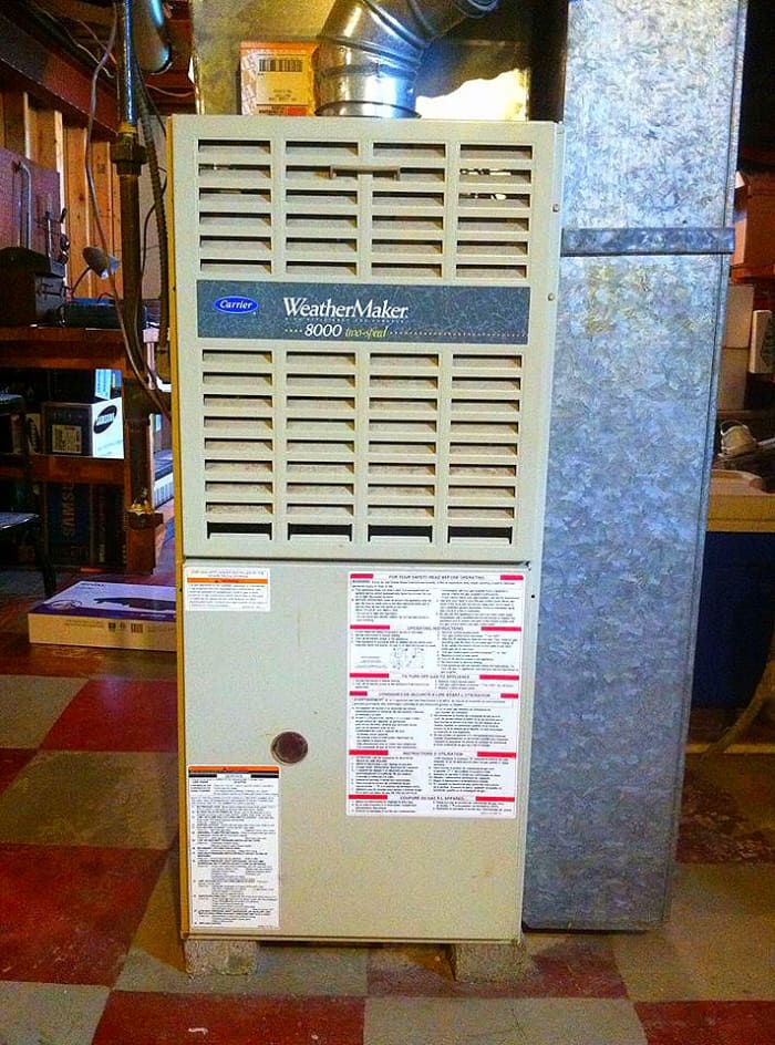 The return air drop, a common location for oil-canning, is on the side of this furnace; in a furnace that blows downward, the return air drop will be connected to the top.
