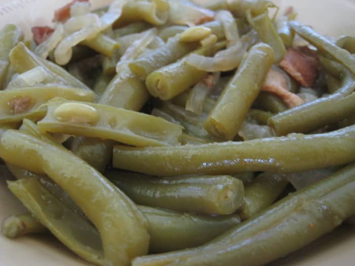 Paula Deen's delicious green beans are seasoned with chicken broth, bacon or salt pork, and onions.