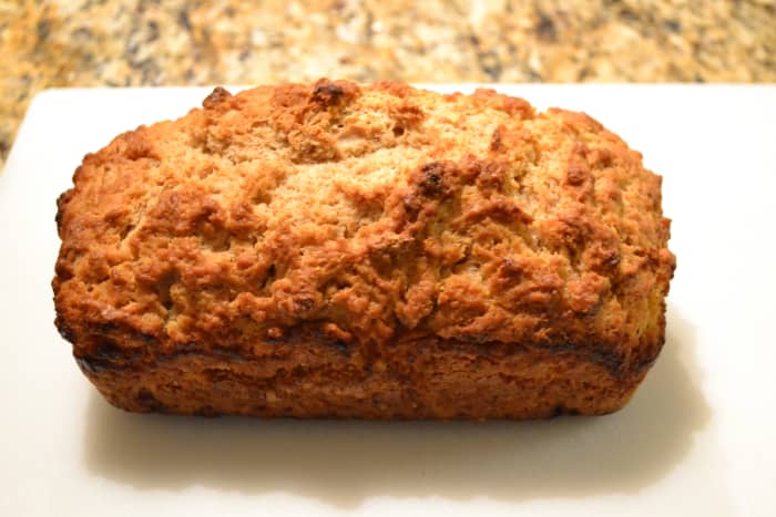 Golden brown beer bread, fresh out of the oven, with a crunchy outer crust, soft inside and lovely golden brown color.