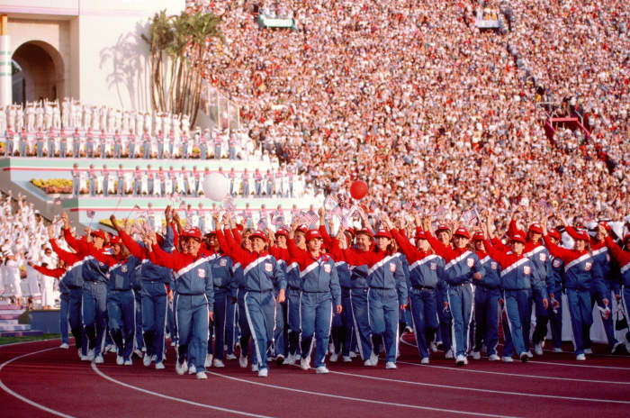 The U.S. Olympic Team marches into the LA Coliseum, to the roar of hordes of visitors.