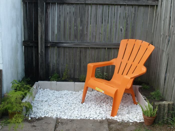 With the addition of marble chips and the Adirondack chair—a little color in orange—the herb garden is complete and ready for a relaxing morning cup of coffee.