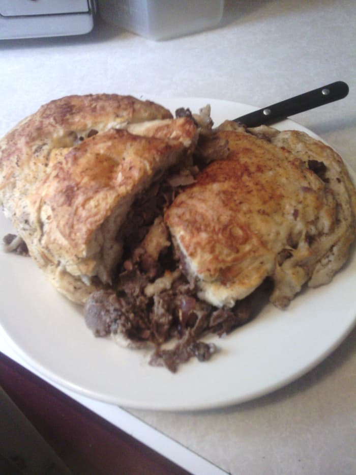 Try making this family-sized hot pocket for your family! It's stuffed with steak, garlic, mushrooms, onions, and cheese.