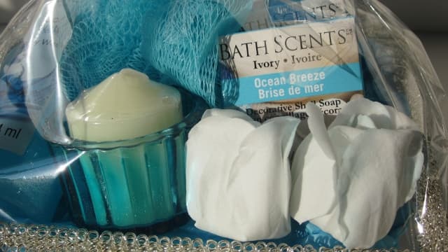 This basket contains turquoise blue accents with a vanilla candle, rose petal soaps, and ocean breeze scents.