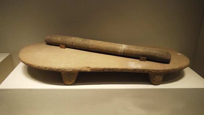 Stone quern and roller, Peiligang culture, 6100 B.C. to 5000 B.C., unearthed at Peiligang, Xinzheng, Henan Province, 1978.