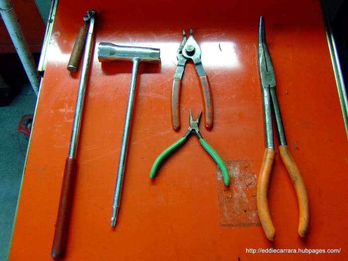 Magnet, snap ring pliers, large and small needle-nose pliers, and a Stihl torx/plug socket.