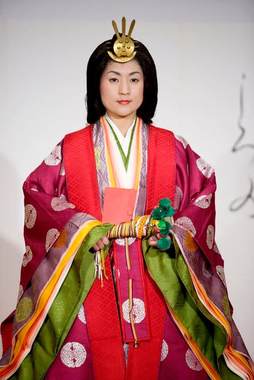 The woman pictured is modeling a Junihitoe kimono, which was the traditional item of dress for women of the Heian court.