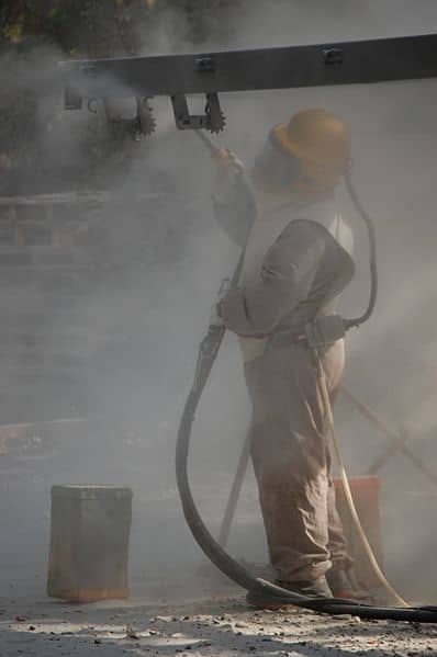 Sandblasting requires the full use of protective clothing to reduce the risk of contracting silicosis.