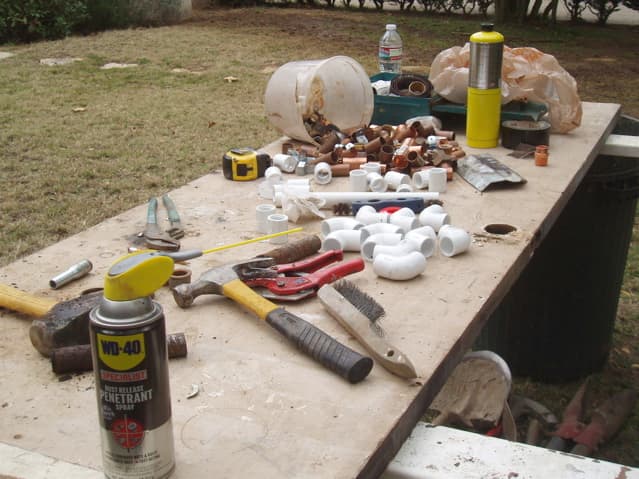 It's important to gather all your parts, supplies, and tools together ahead of time. We set up a table in the middle of the lawn to hold them, which we cover at night with a tarp. Large tools are underneath.