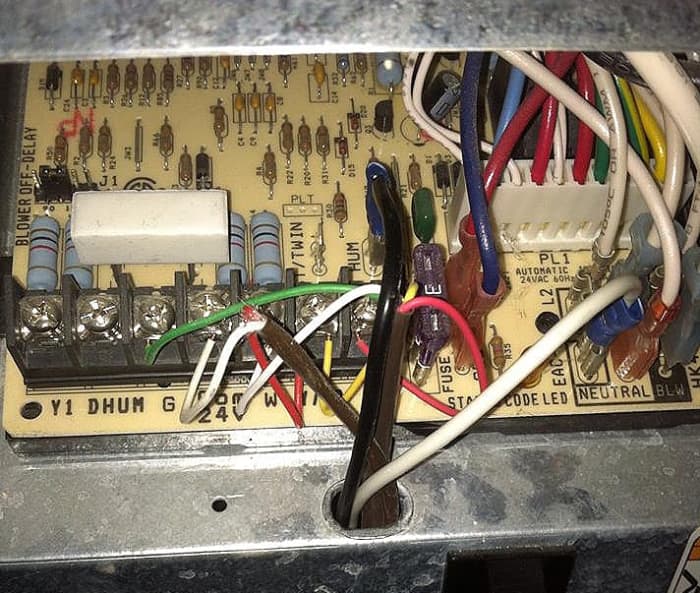 Carefully push the spade connectors onto the circuit board. Black to HUM and white to the 110V Neutral.