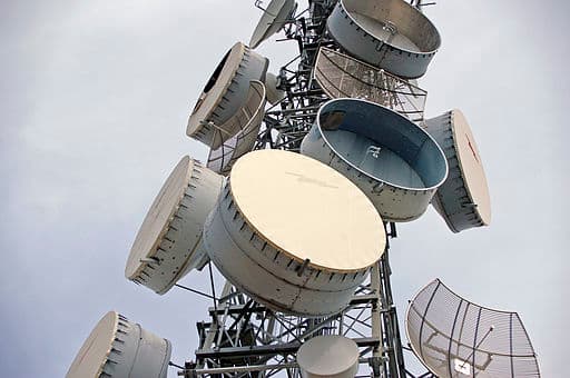 Take a look at the parabolic antennas on a telecommunications tower! Metal shrouds (cylindrical in shape) surround the parabolic dishes. The shrouds shield the antenna from other signals coming from different angles outside its main axis.