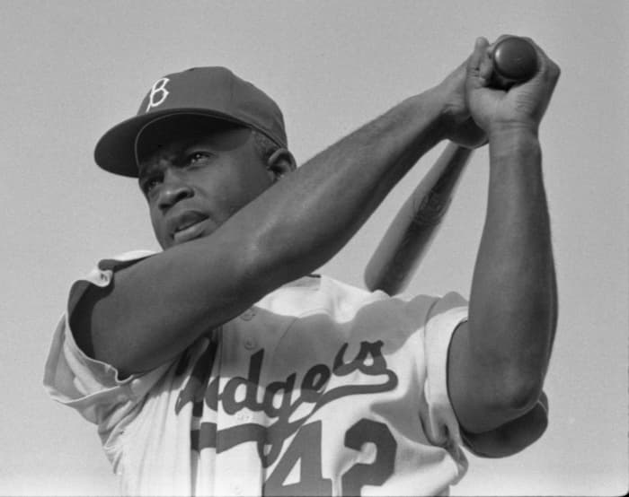 Jackie Robinson, seen above in 1954, was the first African-American player in Major League Baseball. When he broke the color barrier in 1947, he faced harsh treatment from his own teammates, as well as players on opposing teams.