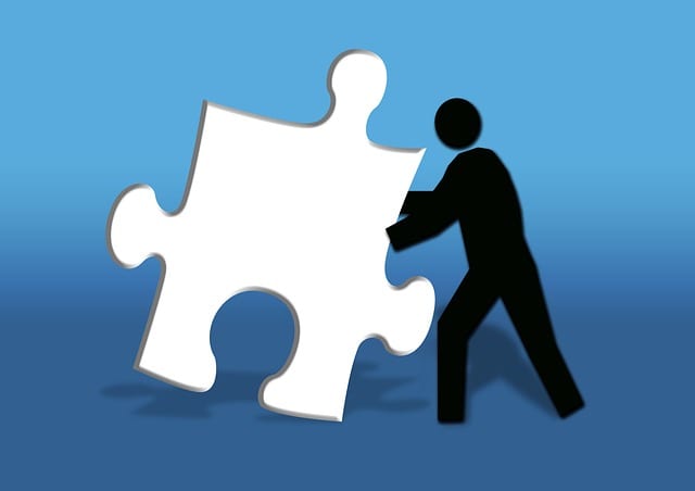 A man searches to place a puzzle piece where it will create a complete picture for him.